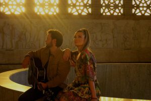 Logan Pietersen performing live on stage with acoustic guitar